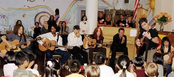 Little Kids Rock - Tom Waits, Bonnie Raitt, Norton Buffalo, Jason Newsted and Austin Willarcy (right to left) take part in jam session at the Spring Valley Elementary School in downtown San Francisco on October 21, 2003. They were there to support the program which was started by David Wish in November 1996 and is a non-profit organization that provides free instruments and lessons to disadvantaged kids in public schools. Some of the artists that serve as board members are Bonnie Raitt, Paul Simon, BB King and Les Paul as well as friend Carlos Santana, Bob Weir and the band, Phish among others.