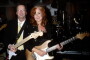 Bonnie Raitt poses with Eric Clapton during her induction ceremony into the Rock and Roll Hall of Fame on March 6, 2000